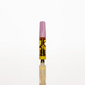 A single disposable vape cartridge standing upright on a reflective white surface against a solid white background. The vape has a light pink mouthpiece, a clear body showing yellow oil, and a black and gold patterned inner section. Thumbnail