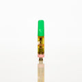 A single small vape oil cartridge with a bright green mouthpiece and clear body showing golden-yellow oil, centered on a seamless white background with a soft reflection below. Thumbnail